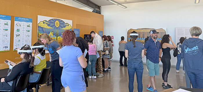 Inside the Audubon Center, where the Agua es Vida art works and interactive exhibition elements are currently housed, while numerous people are engaging with each other, VR headsets and artworks. Photo by Dayanara Avilez.