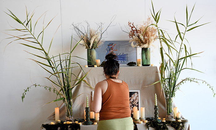 The artist Estephania González stands in front of the ofrenda that she created for the Agua es Vida exhibit. Photo by Franscisco Lara-Valencia.