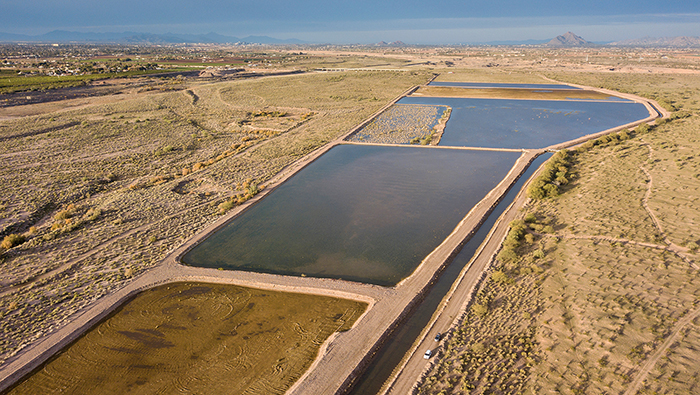 Three very large pools of water in an arid landscape.