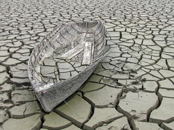Abandoned boat in cracked mud