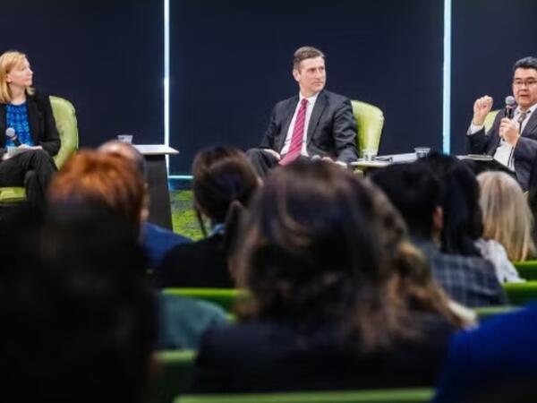 A panel of people on a stage