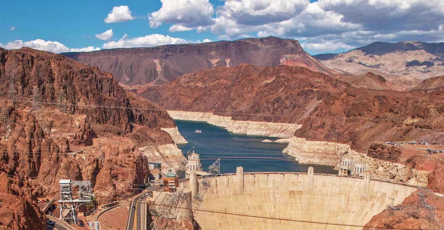 A large dam in a desert redrock landscape. Photo by Karl MPhotography.