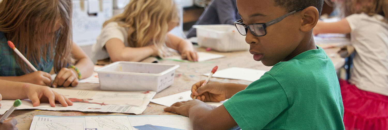 Children work at a table.