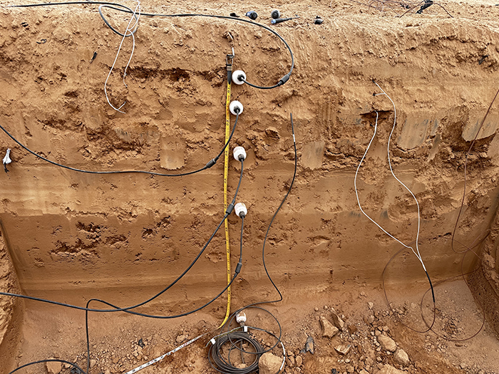 A soil pit loaded with sensors and equipment.