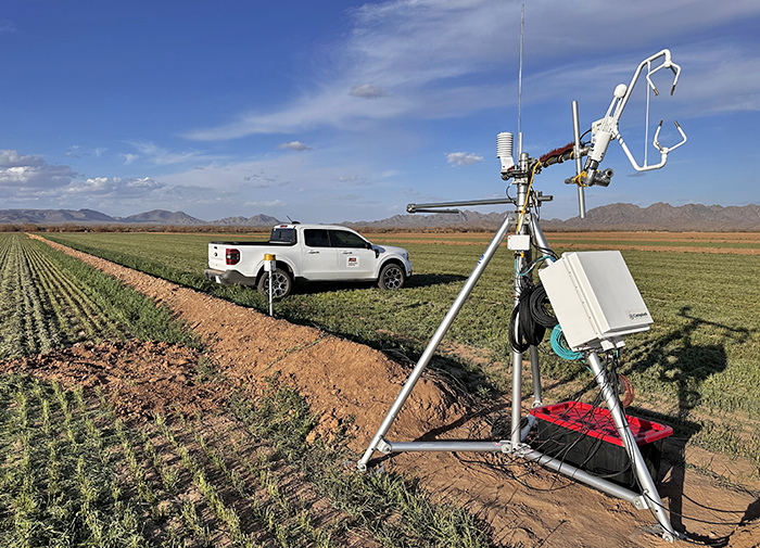 A truck and scientific equipment in a desert ag field.