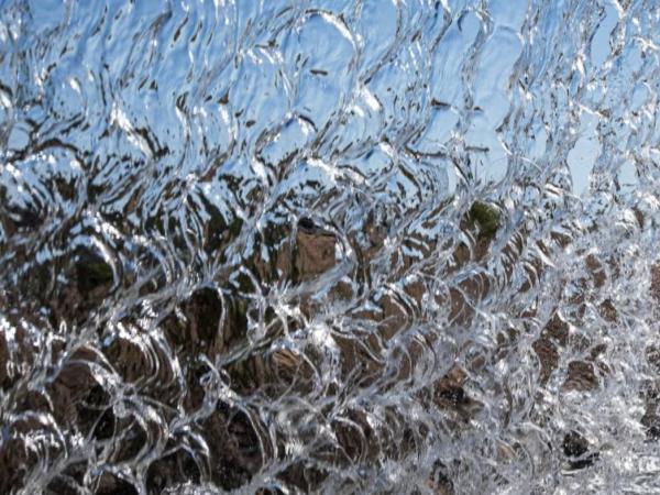 Water falling over a ledge.