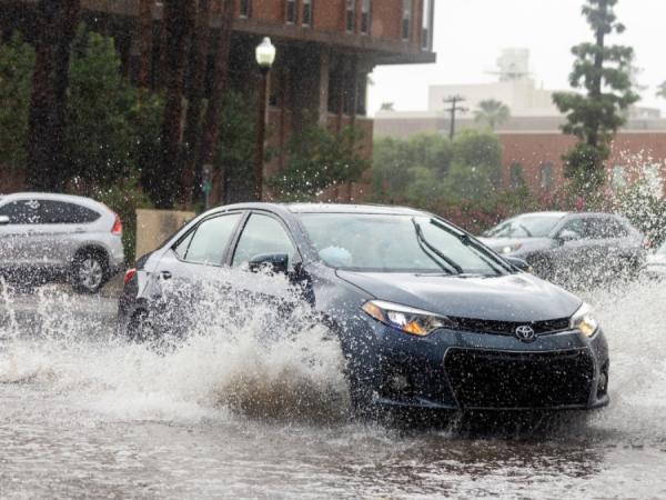 Car driving through a large amount of water.