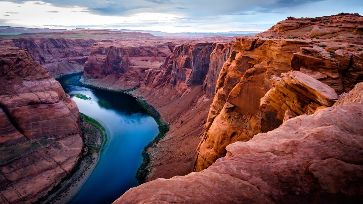 A river winds through dramatic redrock canyon