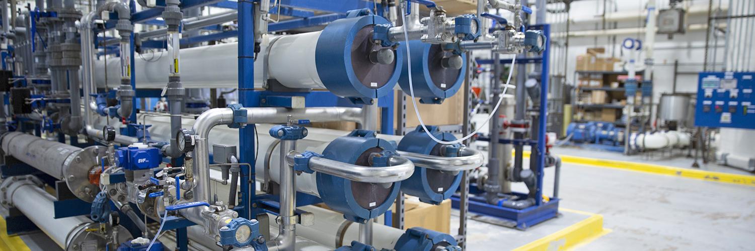 A large series of pipes in a warehouse.